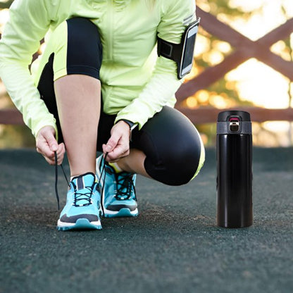 Femme jogging avec isotherme bouteille