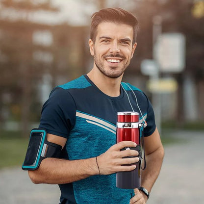 Homme souriant avec gourde isotherme rouge